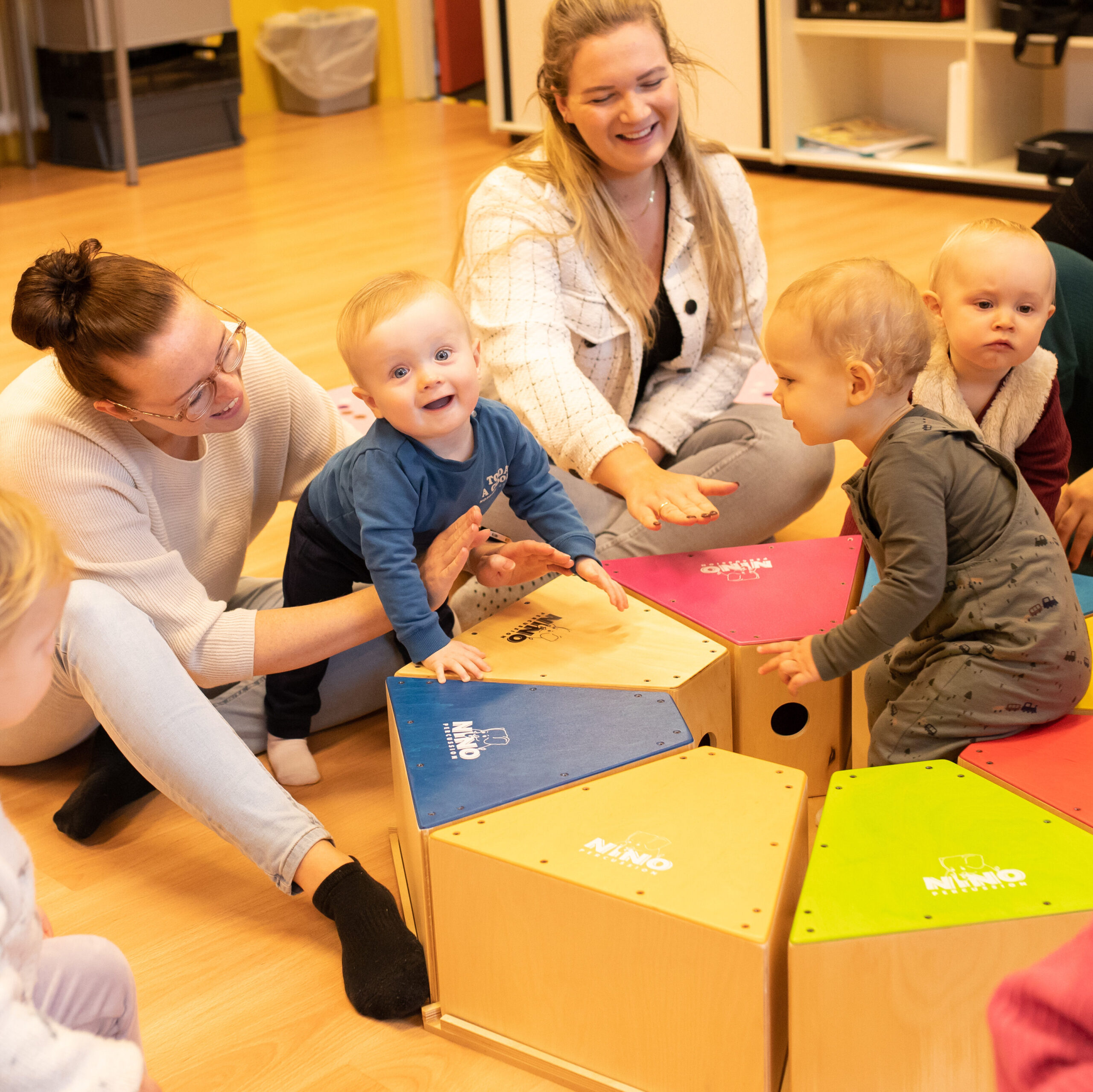 Kinderen spelen met muziekinstrumenten tijdens de les Muziek op Schoot